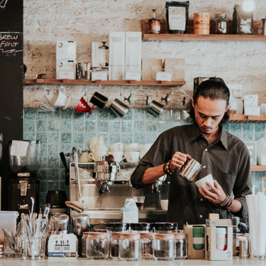 Barista making coffee in cafe