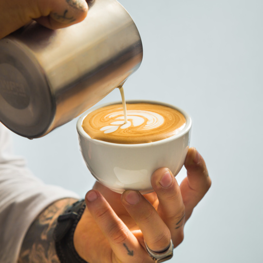Person doing latte art
