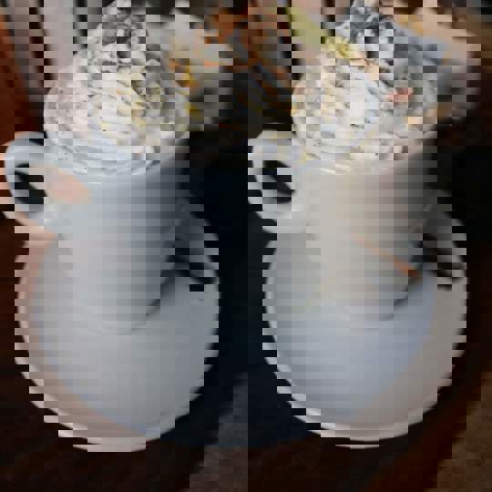 Whipped cream on drink in mug